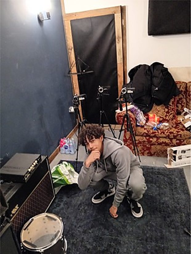 A participant setting up for a video shoot alongside the recording gear